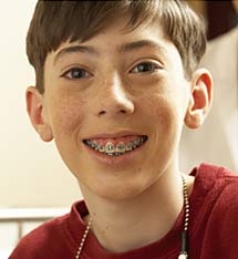photo of a smiling young boy wearing glasses